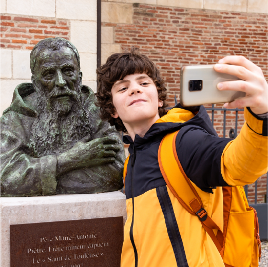 Student taking a selfie with a statue